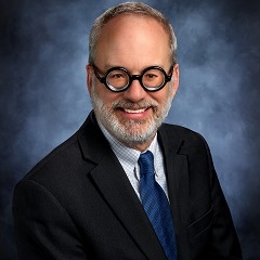 Tim Rosenbury in a suit and tie